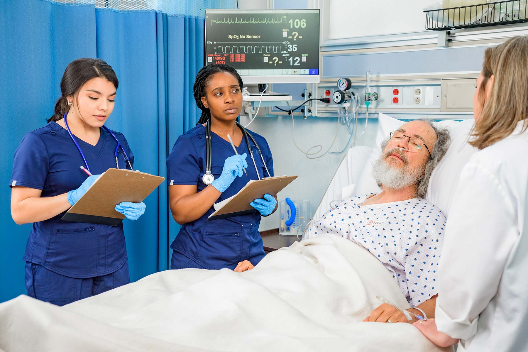 Medical workers standing by the bed of a patient