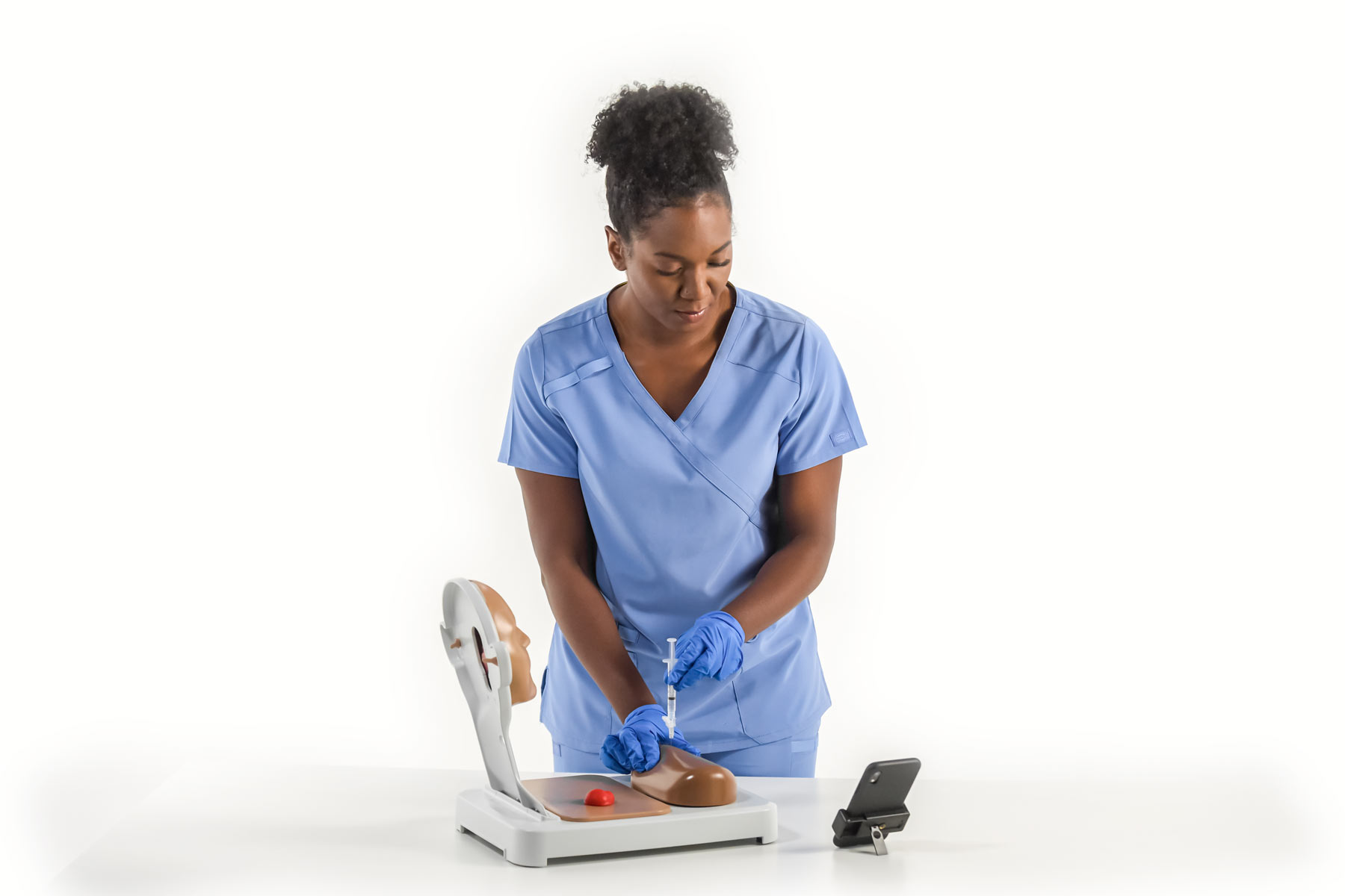 A nurse practicing with equipment