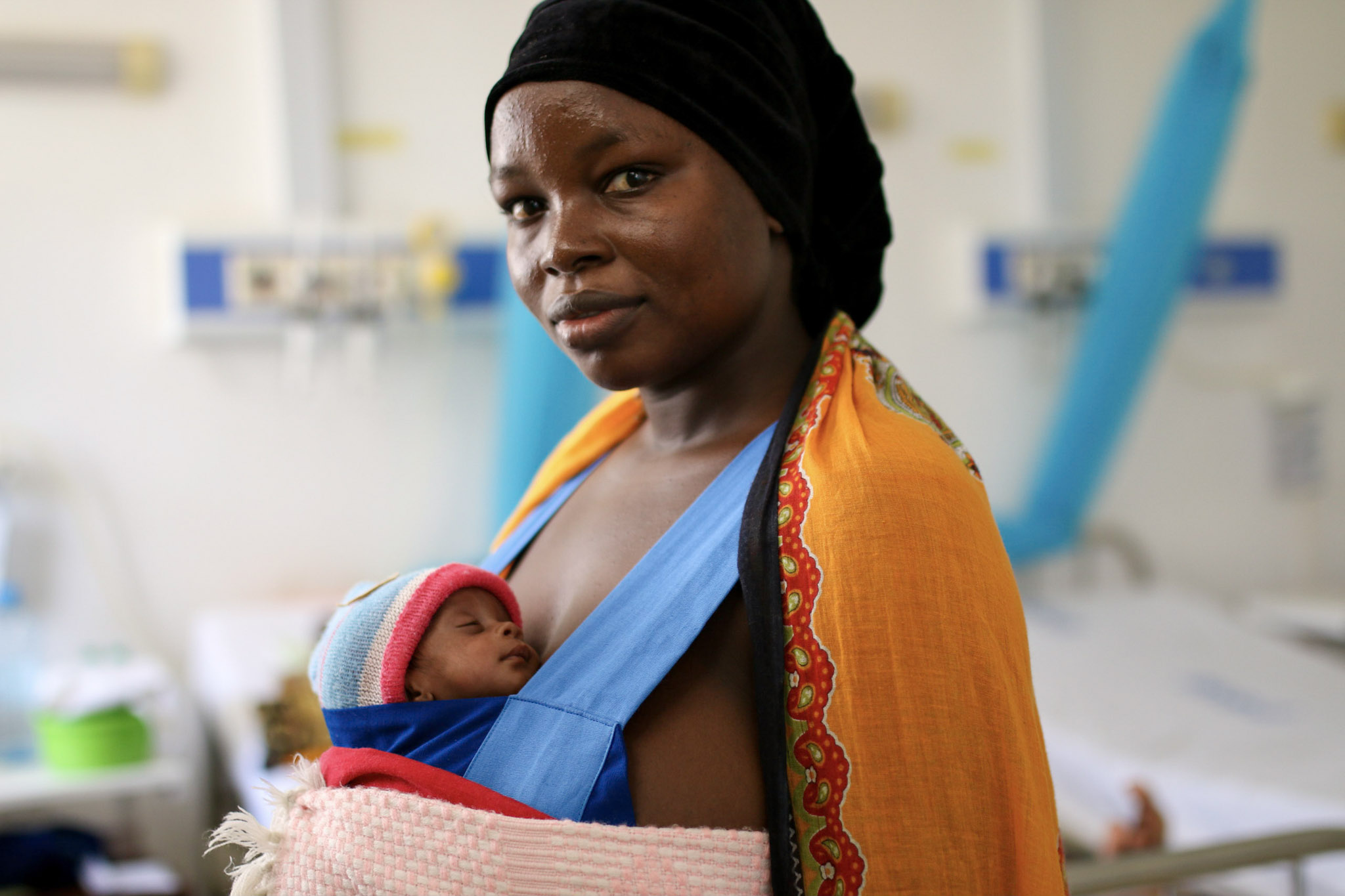 A woman holds a healthy baby in Malawi