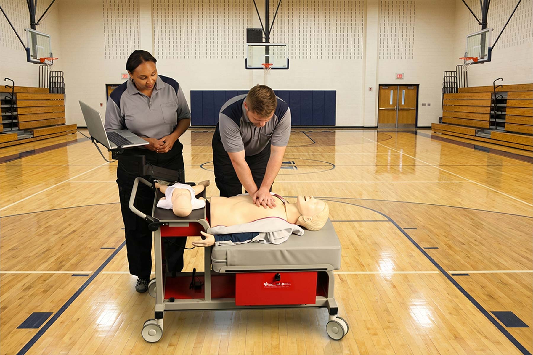 peforming cpr with an rqi cart inside a gymnasium