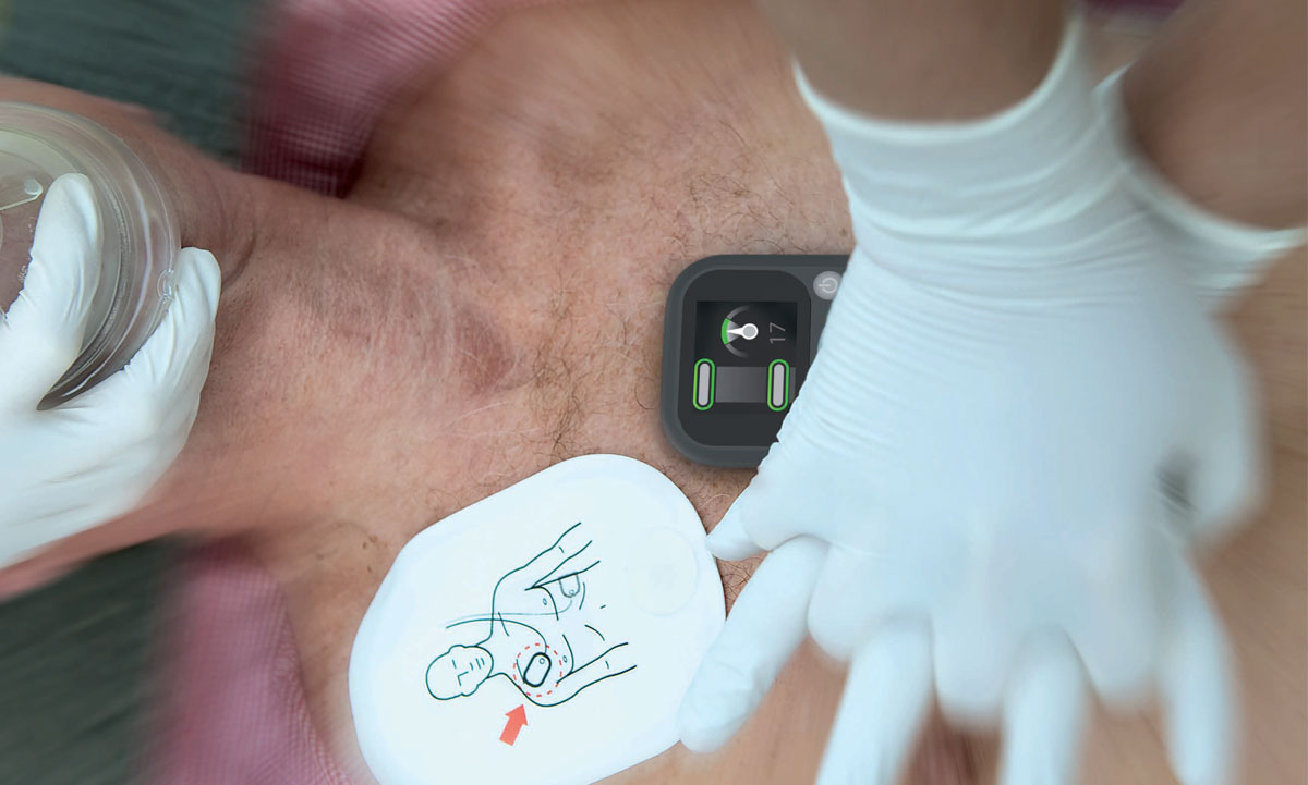 Man being given CPR with the help of CPR feedback device