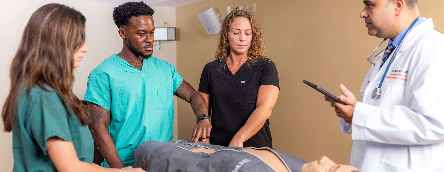 Small group of nursing students working on Harvey, The Cardiopulmonary Patient Simulator