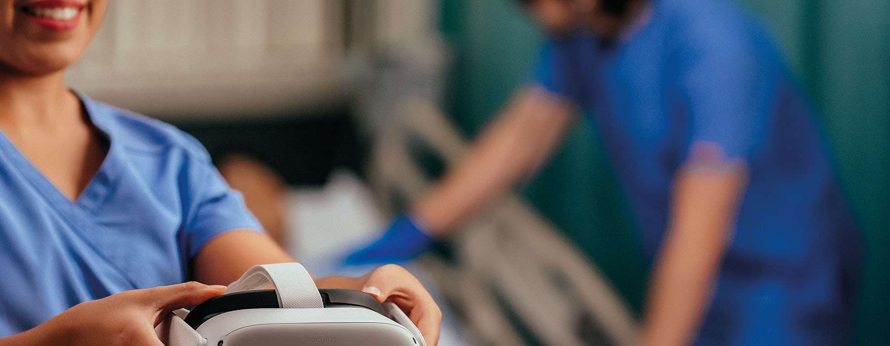A close-up of a nursing student holding a VR headset, ready to begin or just finishing an immersive clinical simulation training session.