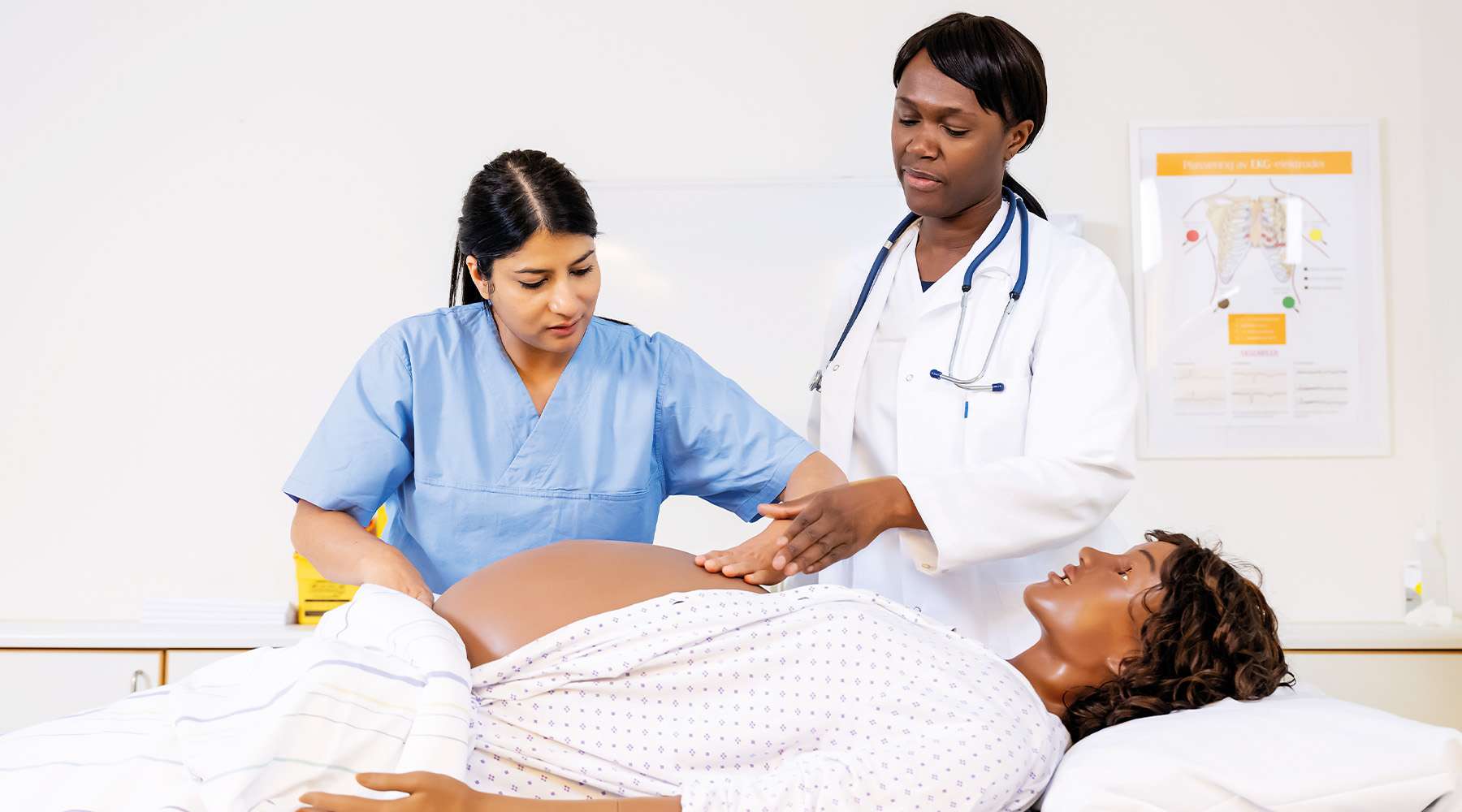 A nursing student being guided by a superior in a simulation training using the MamaAnne manikin.