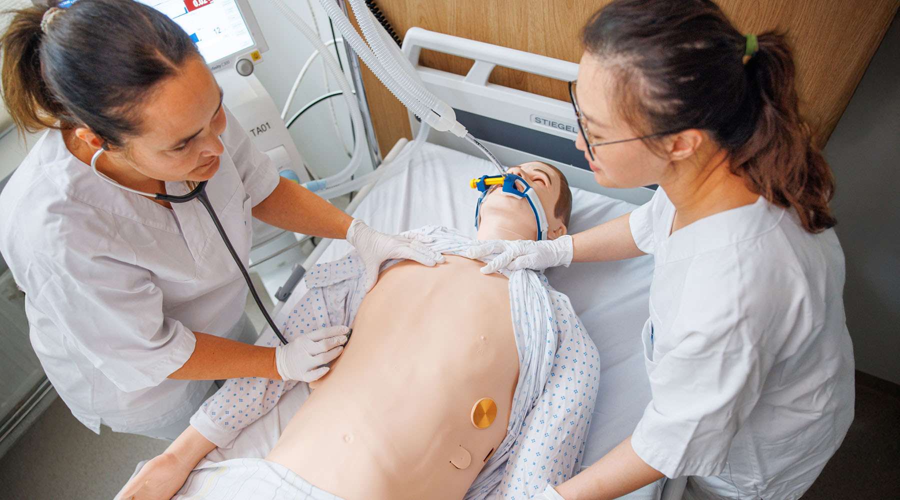 Group of nursing students in critical care simulation training with SimMan
