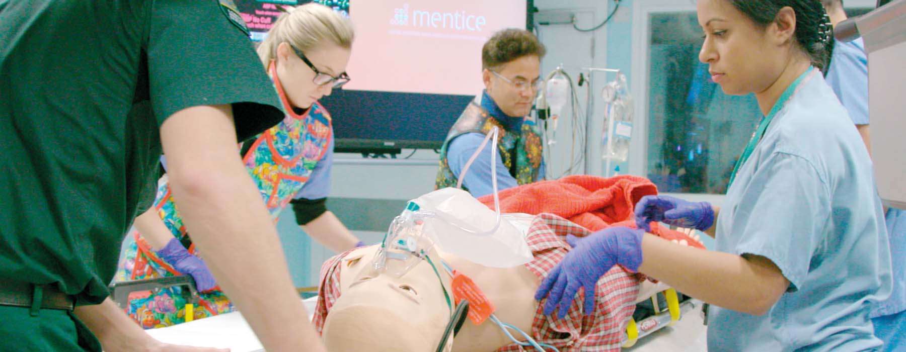 A diverse healthcare team collaborating on a high-fidelity patient simulator during an advanced clinical training session.