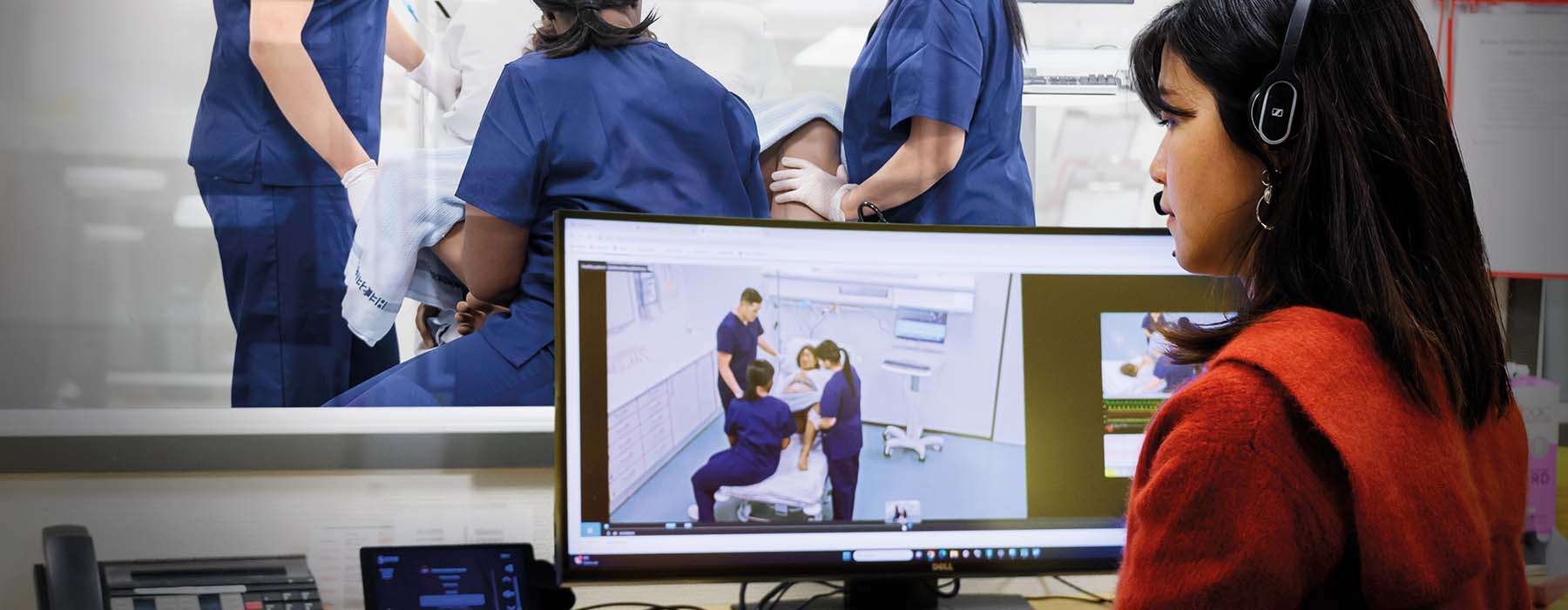 Person in control room using SimCapture to observe simulation training with MamaAnne.