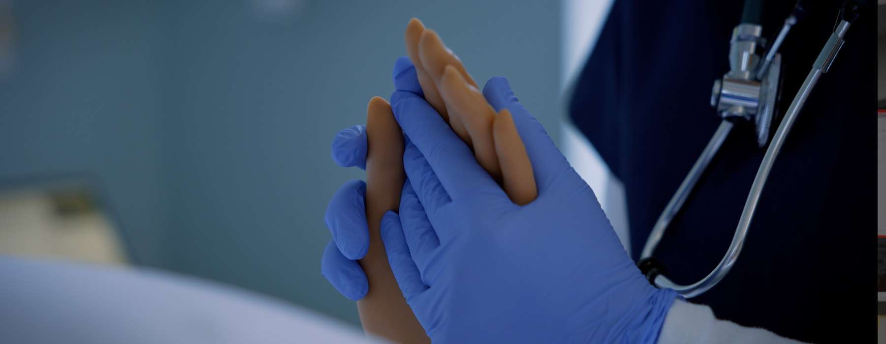 Closeup of glowed hands holding a simulator hand