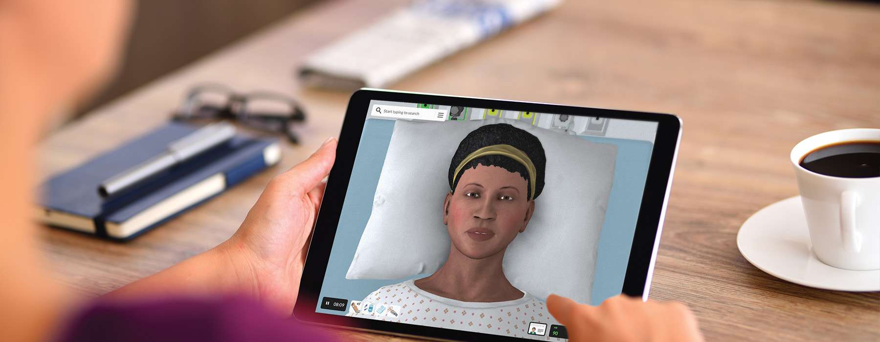 Closeup of someone holding a tablet and using a vSim for Nursing module for training.