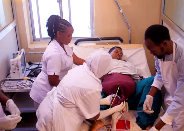 Healthcare workers practice on a laerdal mannikan